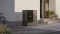 Sur la photo, on peut voir l'unité extérieure Vitocal 200-A ie posée au sol, à gauche de la porte d'entrée d'une maison individuelle au style moderne.